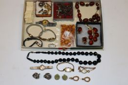 A box containing various ear-rings, wrist watches,