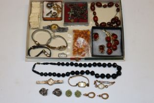 A box containing various ear-rings, wrist watches,