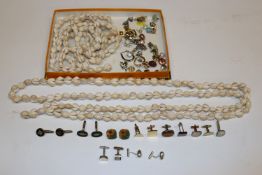 A box containing shell necklaces, various cuff-lin