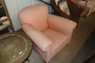 A pink upholstered armchair