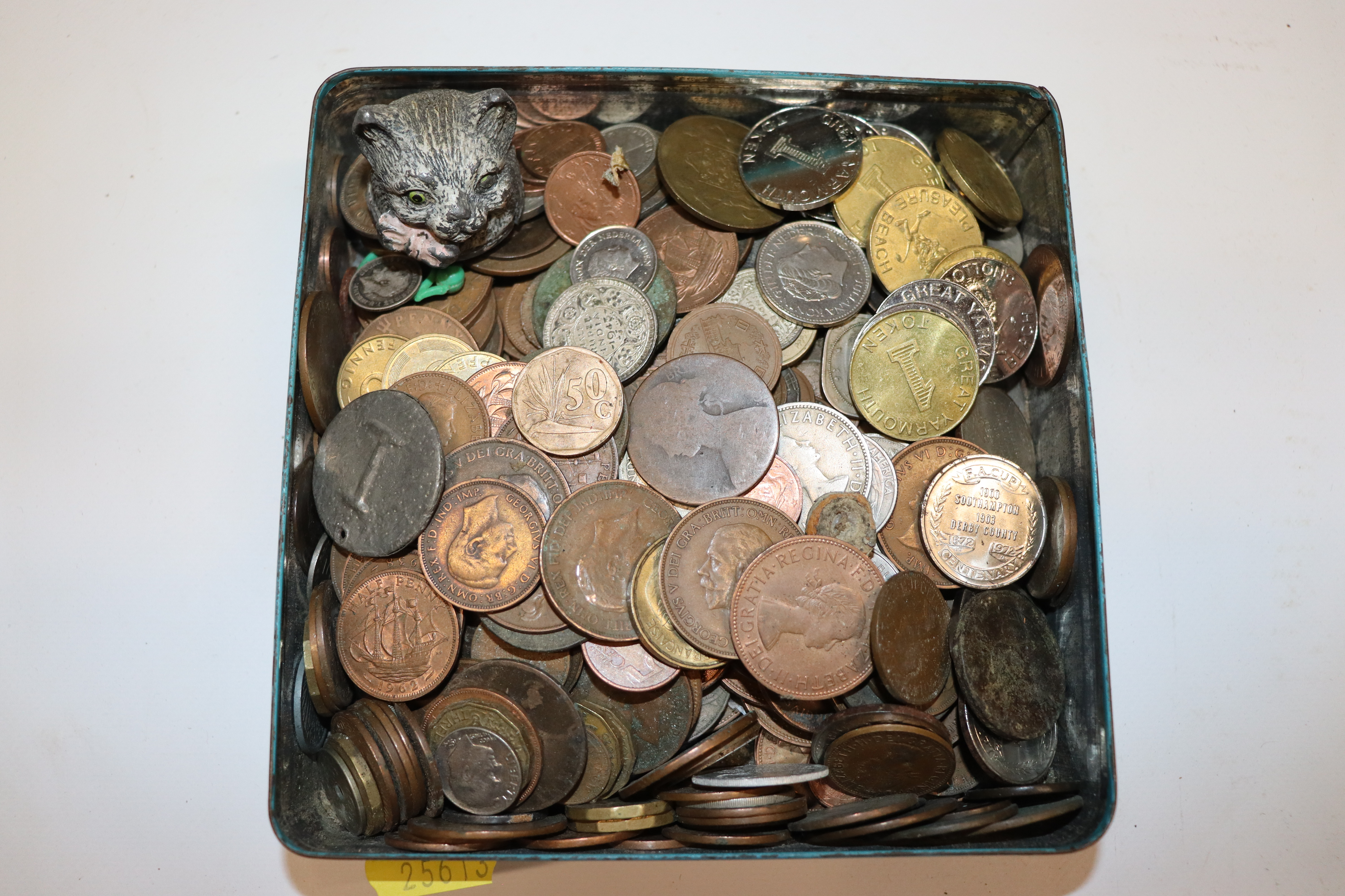 A tin of various coinage