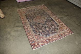 An approx. 6'6" x 4'1" Persian patterned rug AF