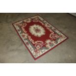 An approx. 5'4" x 3'11" floral patterned rug