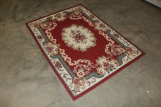 An approx. 5'4" x 3'11" floral patterned rug