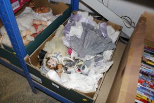A box containing collectors doll and various cloth