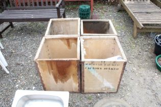 Four wooden tea crates and a roll of plastic wrapp