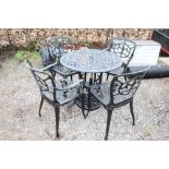 A metal garden table and a set of four matching ch