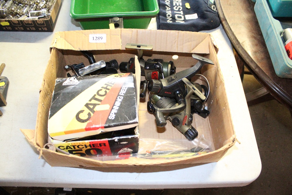 A box of various fishing reel and tackle