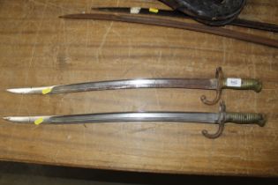 An antique French bayonet and a Remington bayonet