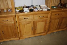 A modern light oak side cupboard fitted two drawer