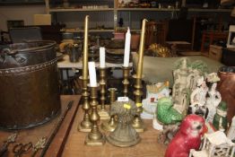 A brass ejector candlestick; one other candlestick