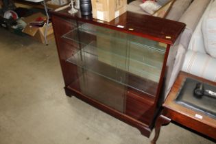 A bookcase fitted with sliding glass doors