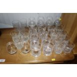 A collection of glass tumblers and brandy balloons