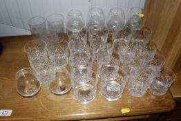 A collection of glass tumblers and brandy balloons