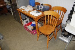 A kitchen table and set of four slat back chairs