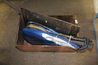 A box containing tennis racquets and balls