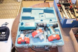 A Makita cordless drill with two spare batteries a