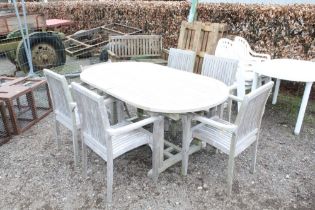 A good quality teak garden table with a set of fiv