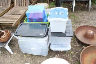 A quantity of plastic storage boxes