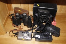 A pair of Swallow 10 x 50 binoculars; a Russian 12 x 40 binoculars and two cameras
