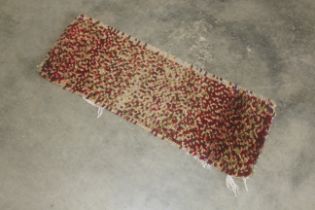 An approx. 2'10" x 1'1" rag rug