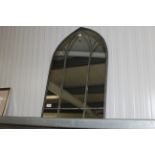 An arch framed wall mirror (148)