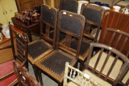 A set of four oak Art Nouveau style dining chairs