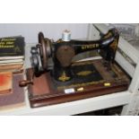 A Singer hand sewing machine lacking case