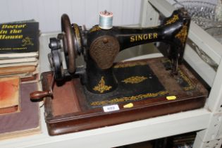 A Singer hand sewing machine lacking case