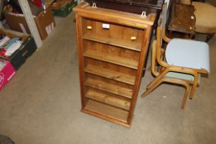 A pine and glazed wall cabinet