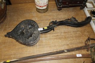 A pair of antique carved oak bellows