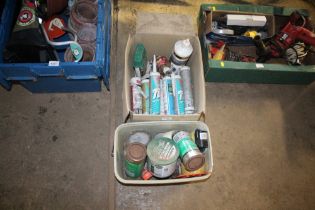 A box containing various silicone, tape, wood fill