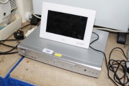 An Alba DVD player and digital calendar clock