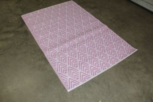 An approx. 6'3" x 4' pink and white modern pattern