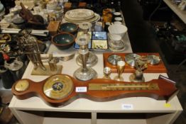 A barometer, candlesticks and a brass figure in th