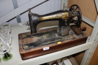 A Singer hand sewing machine lacking case