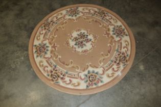 An approx. 4' diameter floral patterned rug