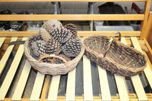 Two wicker baskets and one containing pine cones