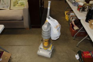 A Dyson dual cyclone upright vacuum cleaner