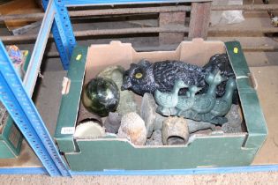 A box containing various garden ornaments, mostly