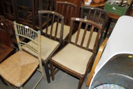 A set of four oak slat back chairs