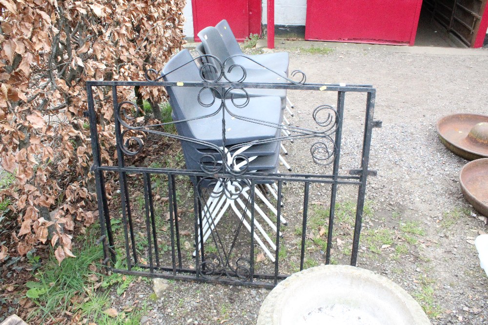 A pair of wrought iron garden gates