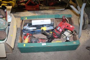 A box containing a 110v disc cutter, drill etc.