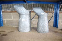 Two galvanised jugs (30)