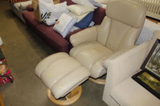 An upholstered reclining chair and matching footst