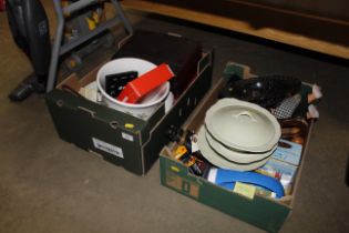 Two boxes containing various dinnerware; cutlery a