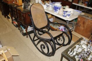 A Thonet style bentwood rocking chair with cane se