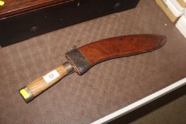 A Kukri knife with leather scabbard