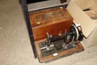 A Frister & Rossman hand sewing machine in fitted
