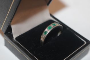 A 9ct white gold emerald and diamond set ring, rin